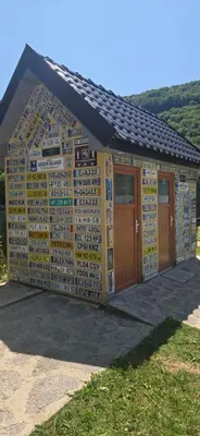 a building with a wall of signs on it at Vikendica, Bazen, Šedrvan, Rafting na Uni, Quad in Bihać