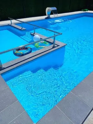 a swimming pool with blue water and two swimming tubes at Vikendica, Bazen, Šedrvan, Rafting na Uni, Quad in Bihać