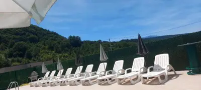 a row of white chairs and umbrellas on a roof at Vikendica, Bazen, Šedrvan, Rafting na Uni, Quad in Bihać