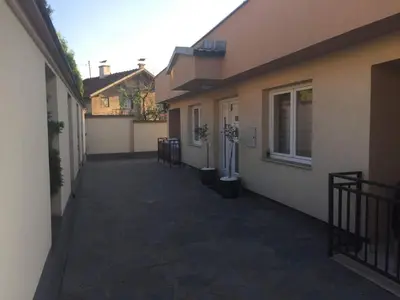an alley between two buildings with potted plants at Villa Orela Zenica in Zenica