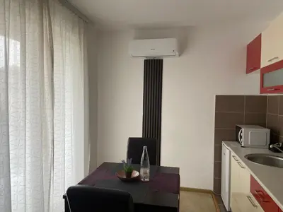 a kitchen with a table with a bottle of wine on it at Villa Orela Zenica in Zenica