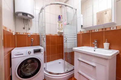 a bathroom with a washing machine and a sink at Apartman Kupres Ski in Kupres