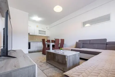 a living room with a couch and a table at Apartman Kupres Ski in Kupres