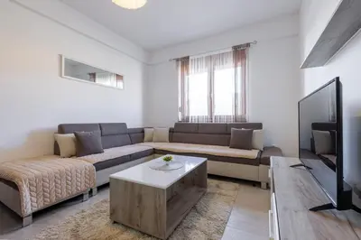a living room with a couch and a tv at Apartman Kupres Ski in Kupres