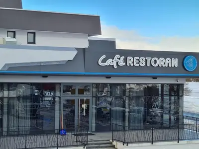 a cafe restaurant with a sign on the front of a building at Motel BTG in Tomislavgrad