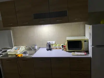 a kitchen counter with a microwave and a sink at BIG Apartment 3 Bedrooms in Bihać