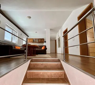 a living room with stairs leading to a dining room at BIG Apartment 3 Bedrooms in Bihać