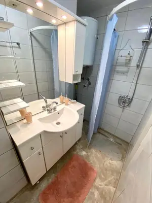 a bathroom with a sink and a mirror at COZY CENTER Apartment Bihać in Bihać