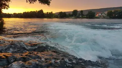 a view of a river at sunset at COZY CENTER Apartment Bihać in Bihać