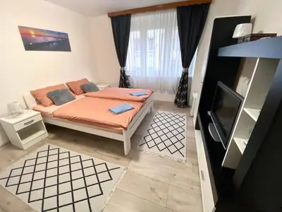 a bedroom with a bed and a television in it at COZY CENTER Apartment Bihać in Bihać