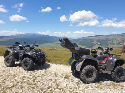 two atvs parked on a hill with mountains in the background at Apartment Dolic - Your peaceful spot with a panoramic view in Livno
