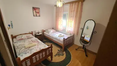 a small room with two beds and a mirror at Apartment Dolic - Your peaceful spot with a panoramic view in Livno