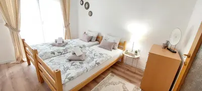 a bedroom with two beds and a mirror on the wall at MB Deluxe Apartment in Visoko