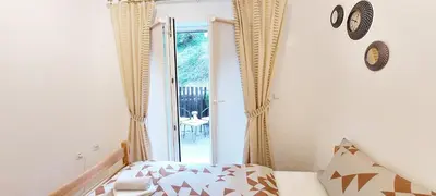 a bedroom with a bed and a sliding glass door at MB Deluxe Apartment in Visoko