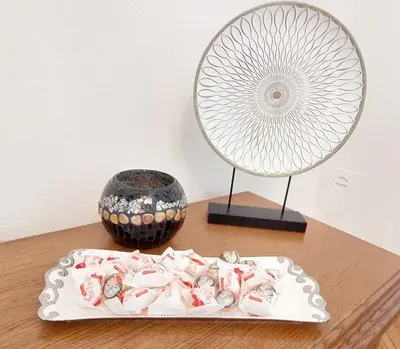 a table with a plate and a fan and a bowl at MB Deluxe Apartment in Visoko