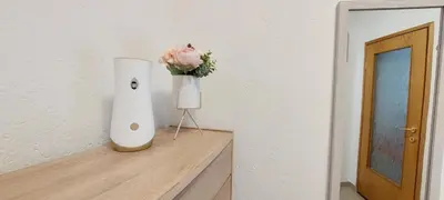 a vase with a flower on top of a table at MB Deluxe Apartment in Visoko