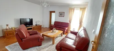 a living room with a couch and chairs and a tv at MB Deluxe Apartment in Visoko