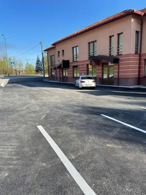 a car parked in a parking lot in front of a building at Exclusive apartments Visoko 2022 in Visoko