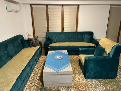 a living room with blue couches and a coffee table at Exclusive apartments Visoko 2022 in Visoko