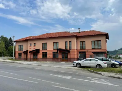 a building with two cars parked in front of it at Exclusive apartments Visoko 2022 in Visoko