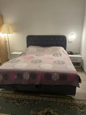 a bedroom with a bed with a pink bedspread at Exclusive apartments Visoko 2022 in Visoko