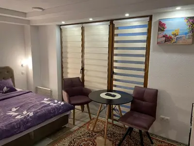 a bedroom with a bed and a table and chairs at Exclusive apartments Visoko 2022 in Visoko
