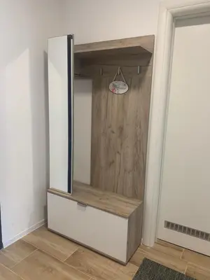 a closet with a mirror and a wooden door at VIP Apartment Visoko in Visoko