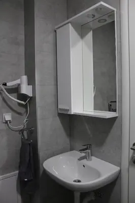 a bathroom with a white sink and a mirror at VIP Apartment Visoko in Visoko