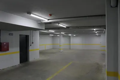 an empty parking garage with yellow and white walls at VIP Apartment Visoko in Visoko