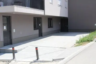 a building with two poles in front of it at VIP Apartment Visoko in Visoko