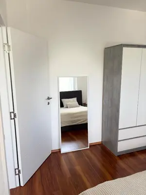 a bedroom with a mirror and a bed at Lena in Jajce