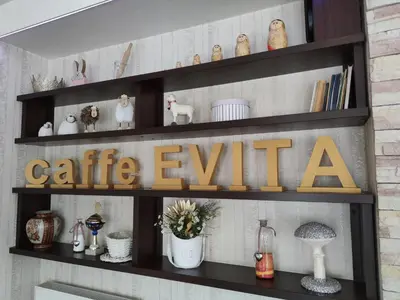 a shelf with a caffe exit sign on it at Evita Apartmani Šibovska in Prnjavor