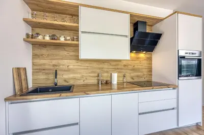 a kitchen with white cabinets and a sink at Villa Hill with Private Pool in Bosanska Krupa