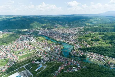 an aerial view of a town next to a river at Villa Hill with Private Pool in Bosanska Krupa