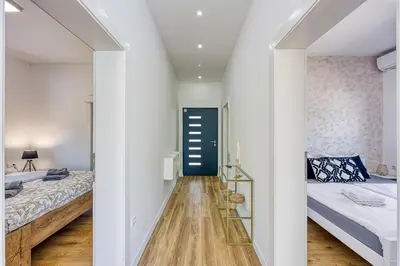 a hallway with two beds and a blue door at Villa Hill with Private Pool in Bosanska Krupa