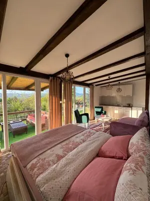 a large bedroom with a large bed and a large window at Perla Accommodation in Visoko