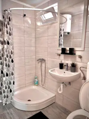 a bathroom with a tub and a sink and a toilet at Perla Accommodation in Visoko