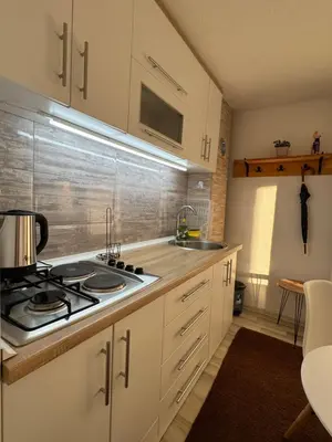 a kitchen with white cabinets and a stove and sink at Perla Accommodation in Visoko