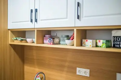 a kitchen shelf with food items on it at Liberty Apartments in Tuzla