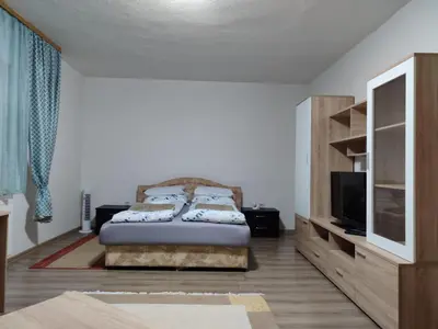 a bedroom with a bed and a tv in a room at Apartment Hatinac in Bihać