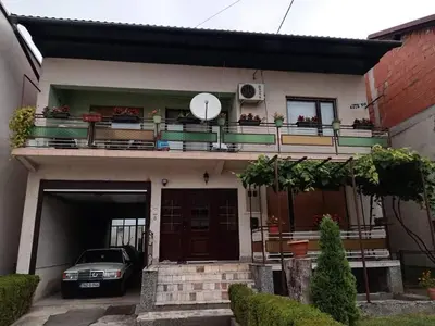 a house with a car parked in front of it at Apartment Hatinac in Bihać
