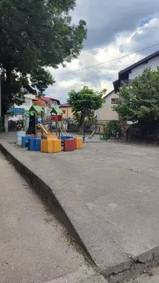 a playground with colorful play equipment on a street at Apartment Hatinac in Bihać