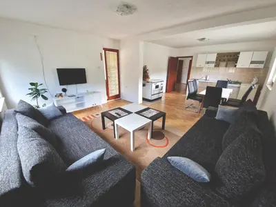 a living room with a couch and a table at Apartman Komfor in Banja Luka