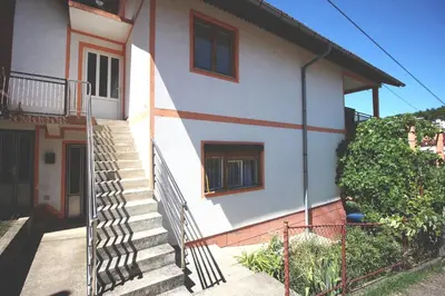 a house with stairs in front of it at Apartman Komfor in Banja Luka
