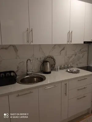 a kitchen with a sink and a counter top at Mercy Deluxapartment in Visoko