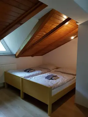 a bedroom with two beds in a attic at Studio apartman Ivana in Jajce