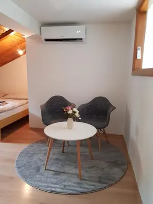 a living room with two chairs and a table at Studio apartman Ivana in Jajce