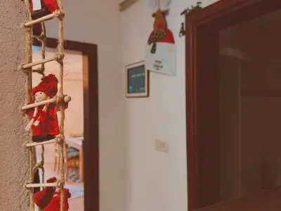 a christmas ornament hanging on a wall next to a door at Villa 