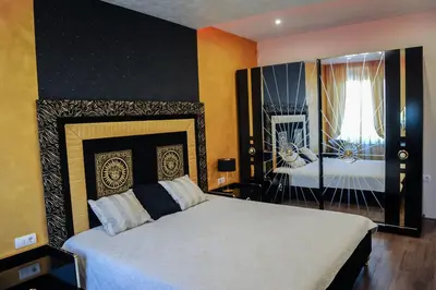 a bedroom with a large white bed and a window at Apartmani President I in Banja Luka