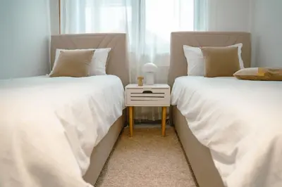 two beds sitting next to each other in a bedroom at Paradise in Bihać